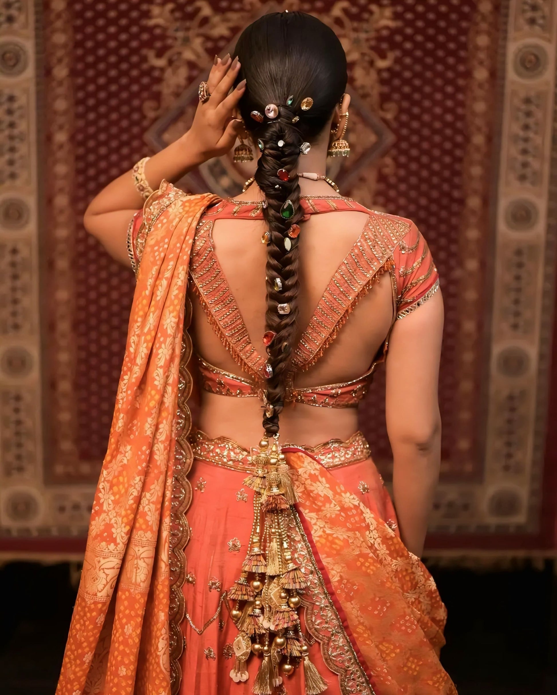 Rust orange embroidered princess cut blouse with deep V back and dori tassels