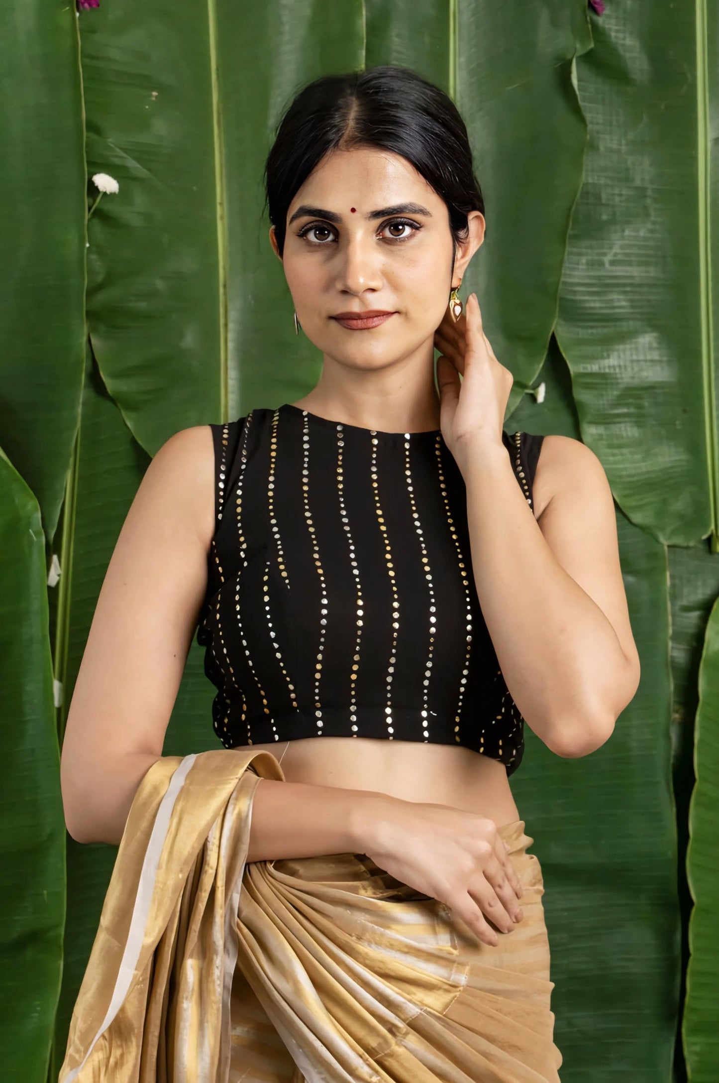 Black fancy blouse design with gold dotted stripes and sleeveless high neck style