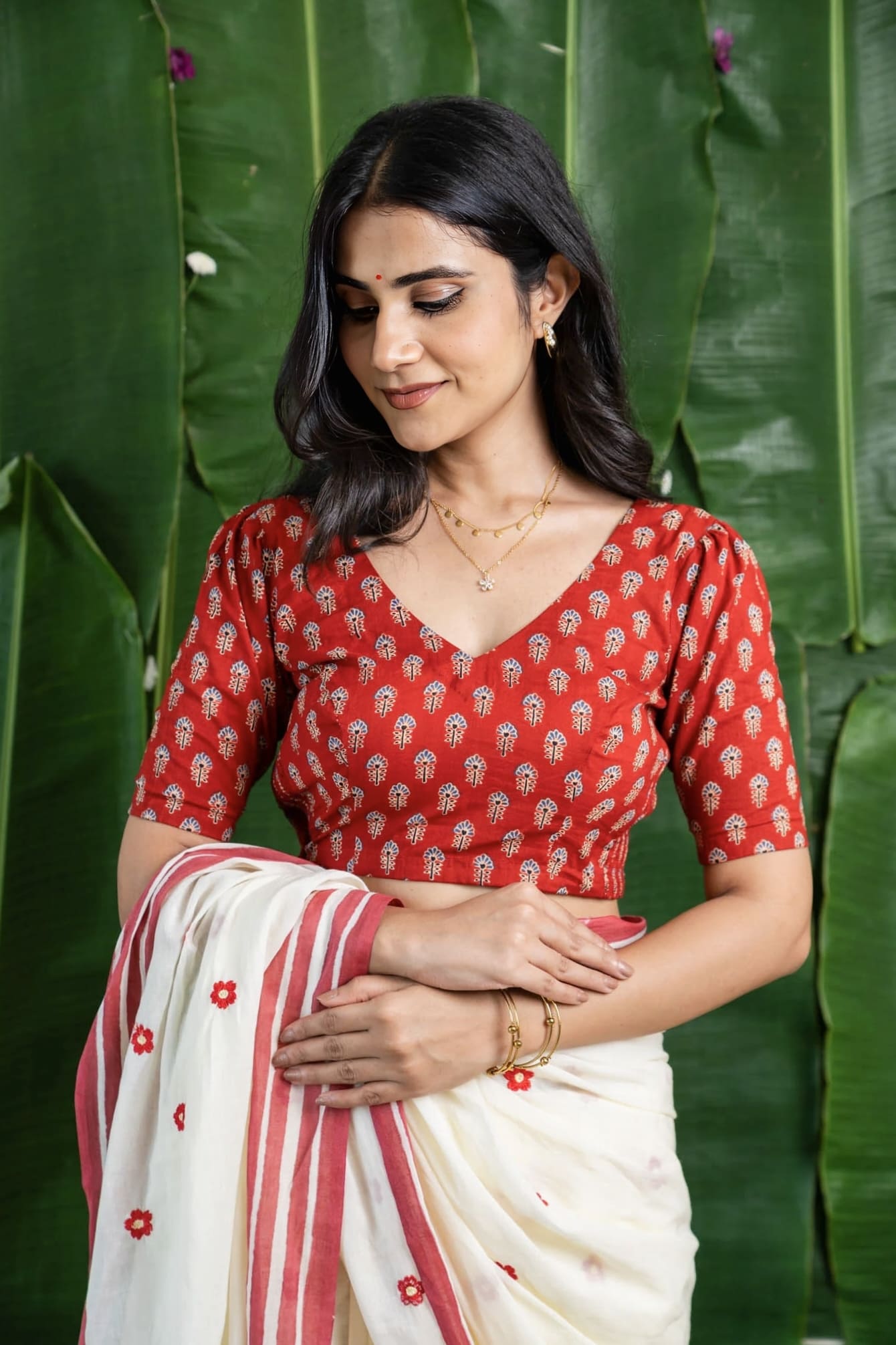 Red printed fancy blouse design with V-neck and elbow sleeves for saree