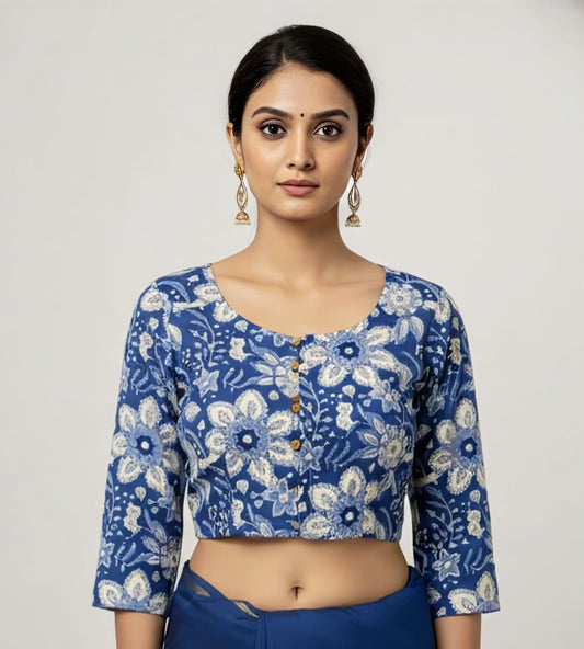 Indigo floral fancy blouse design with round neckline and 3/4 sleeves styled for festive and wedding saree wear.