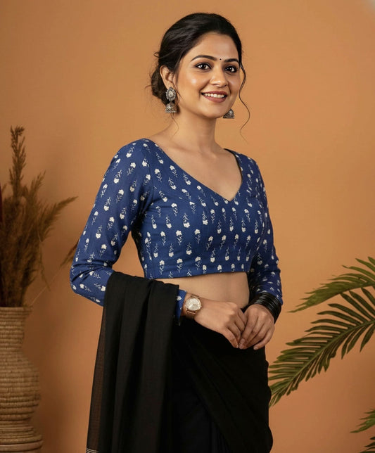 Blue printed fancy blouse design with V neckline and full sleeves paired with black saree.