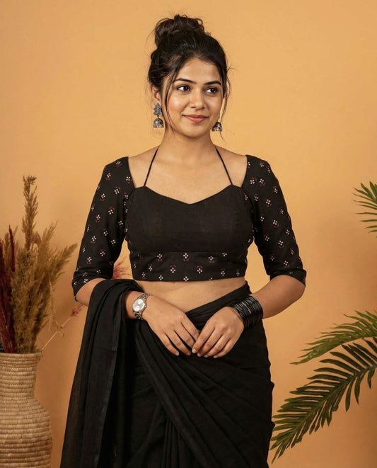 Black fancy blouse design with strappy neckline and printed three-quarter sleeves for party wear saree styling.
