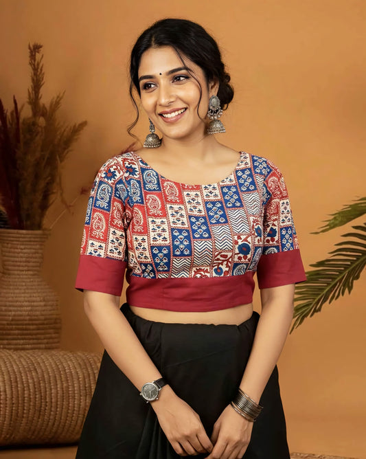Multicolor designer printed blouse with red border and half sleeves styled with black saree.