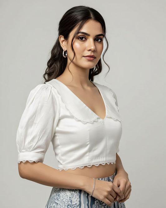 White V neck blouse with puff sleeves and lace trim styled with printed saree.