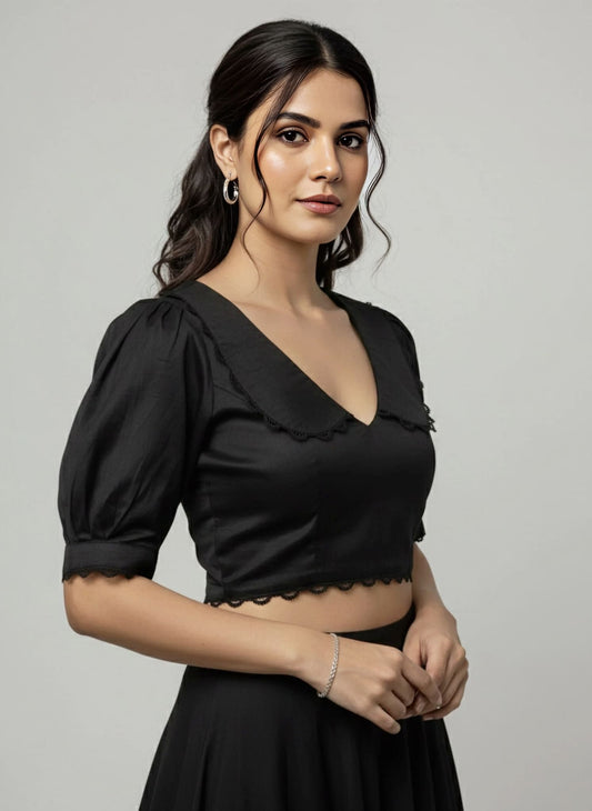 Black V neck blouse with puff sleeves and lace trim styled for saree and evening wear.