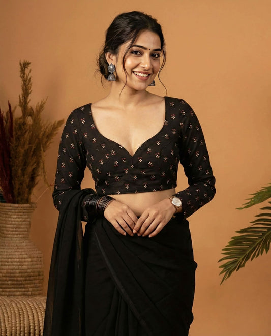 Black sweetheart neck blouse with long sleeves and floral print styled with saree.