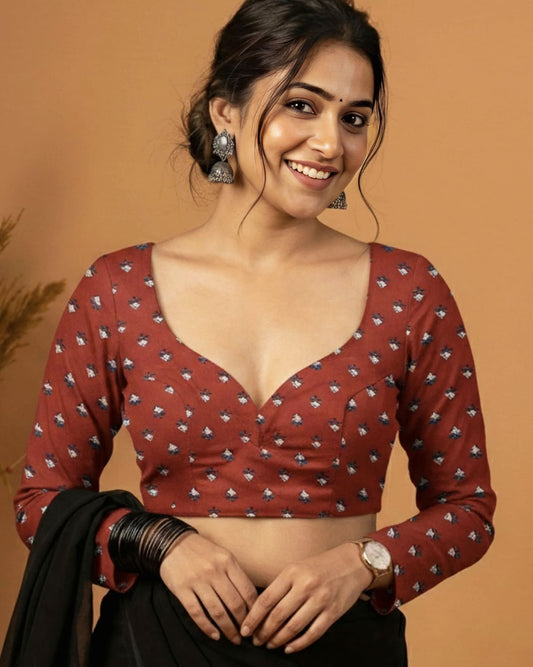 Maroon printed full sleeve fancy blouse design with sweetheart neckline paired with black saree