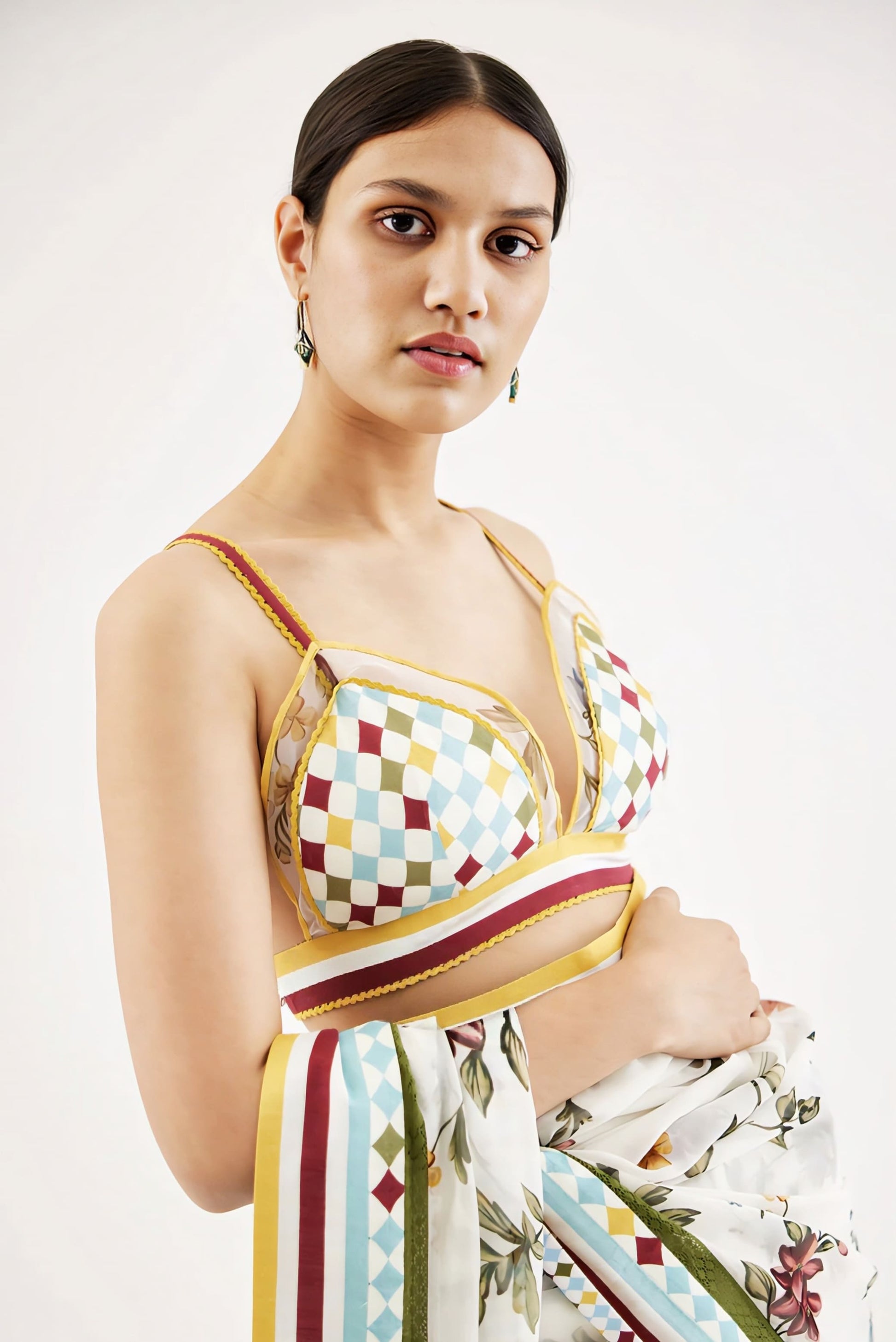 Multicolor printed saree blouse with geometric pattern and contrast striped detailing for festive wear.