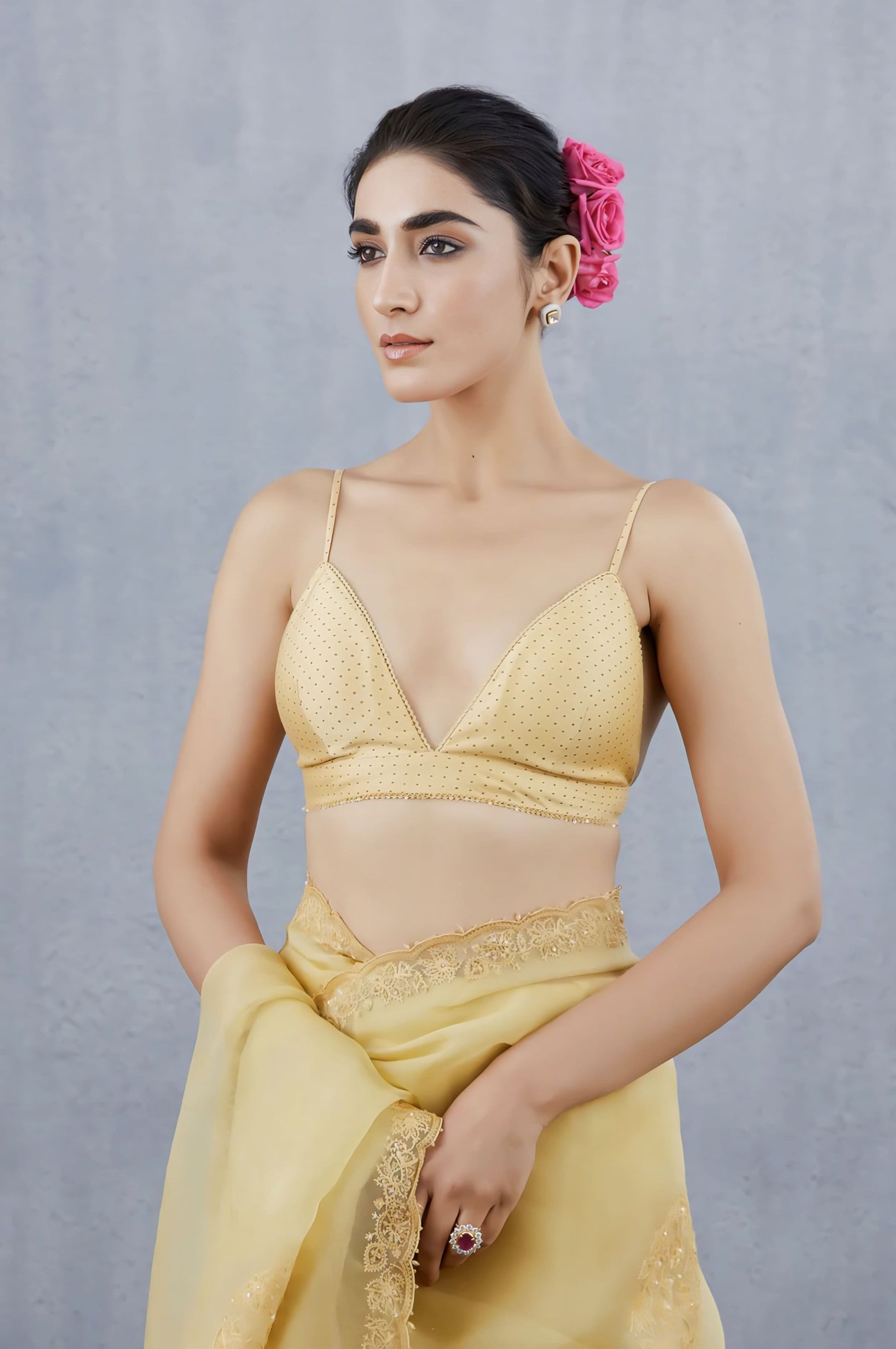 Golden spaghetti strap deep V-neck fancy blouse design paired with pastel yellow saree