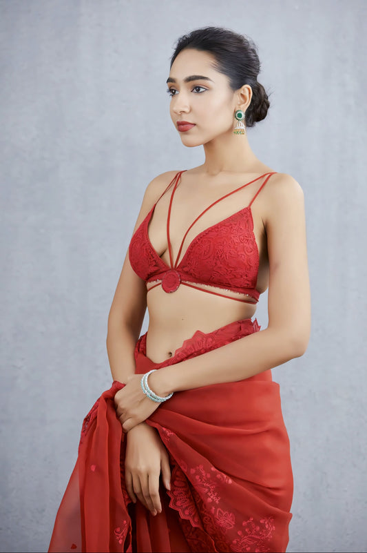Red deep V neck strappy fancy blouse design paired with red saree