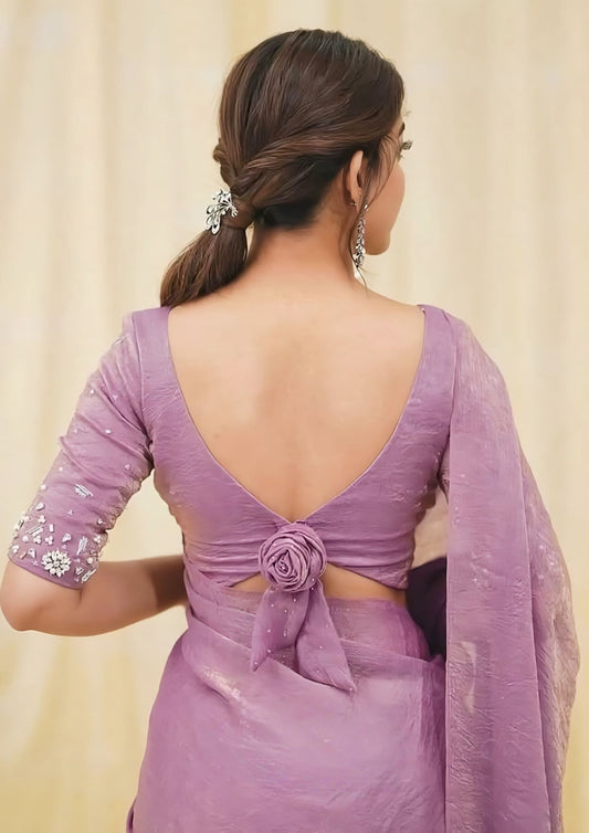Elegant fancy blouse back design featuring deep V neckline with decorative rose knot paired with purple saree