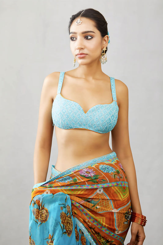 Sky blue embroidered fancy blouse design with sweetheart neckline paired with printed saree