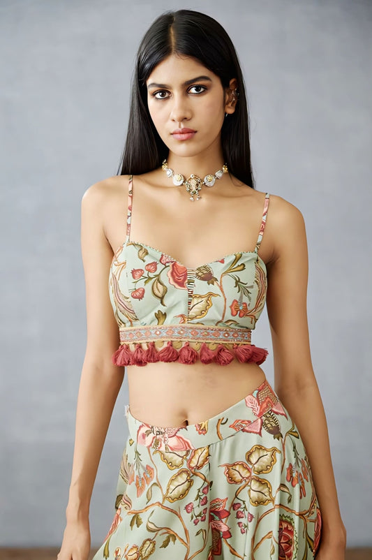 Floral printed fancy blouse design with tassels and spaghetti straps paired with lehenga