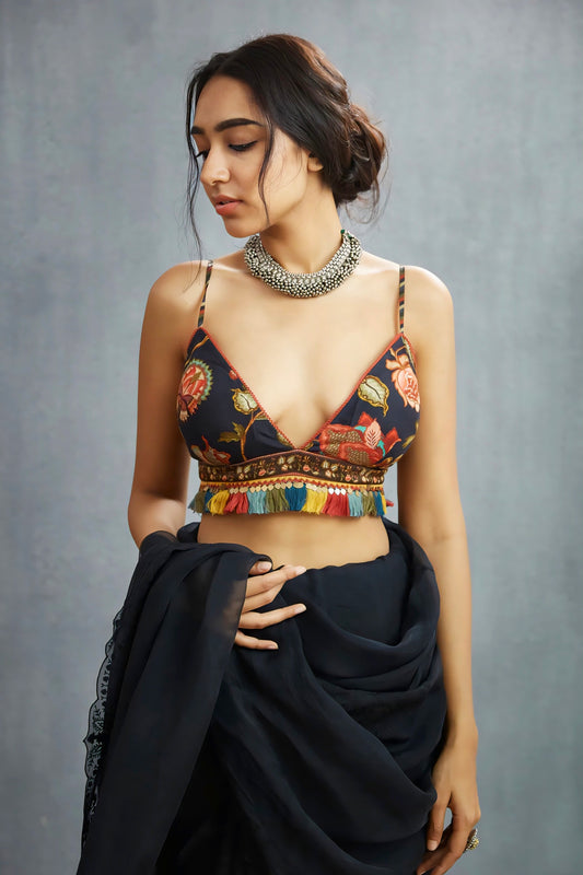 Deep neck floral fancy blouse design with multicolor tassels paired with black saree