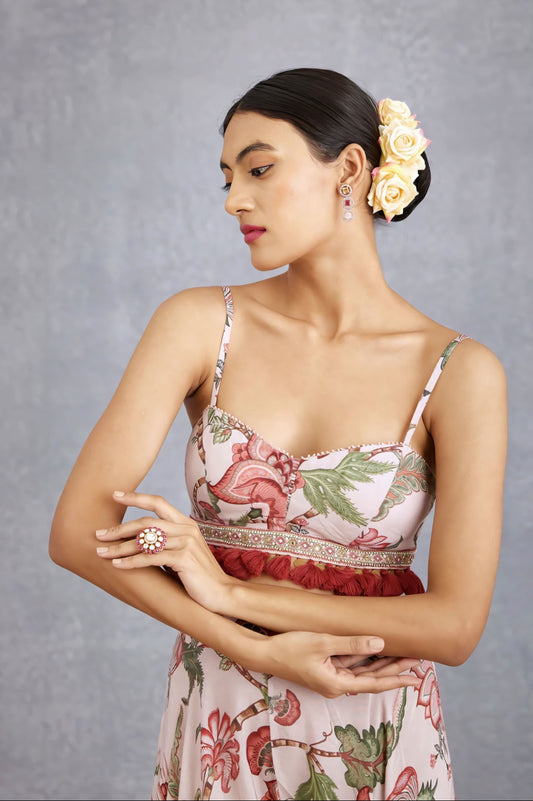 Floral fancy blouse design with tassel detailing and sweetheart neckline in soft pastel pink tones.