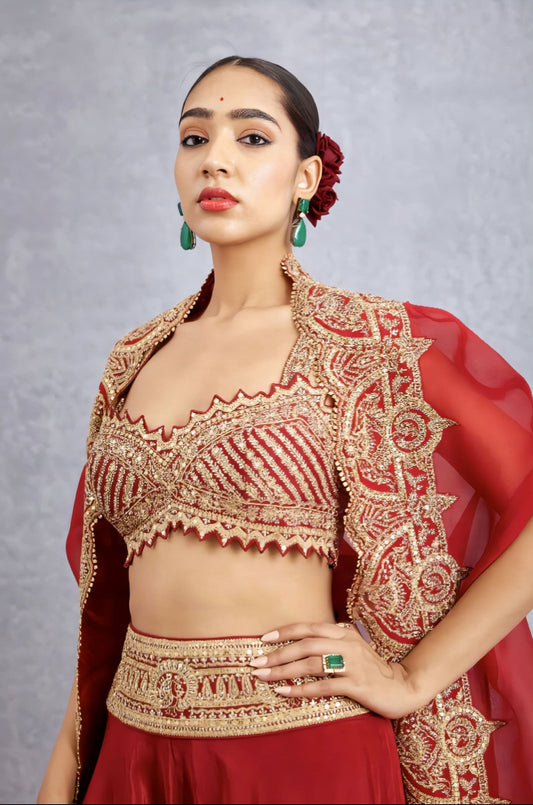 Red bridal fancy blouse design with heavy zari embroidery and scalloped neckline for wedding wear.