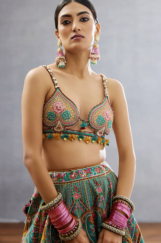 Multicolor fancy blouse design with heavy embroidery and tassel detailing paired with a festive lehenga.