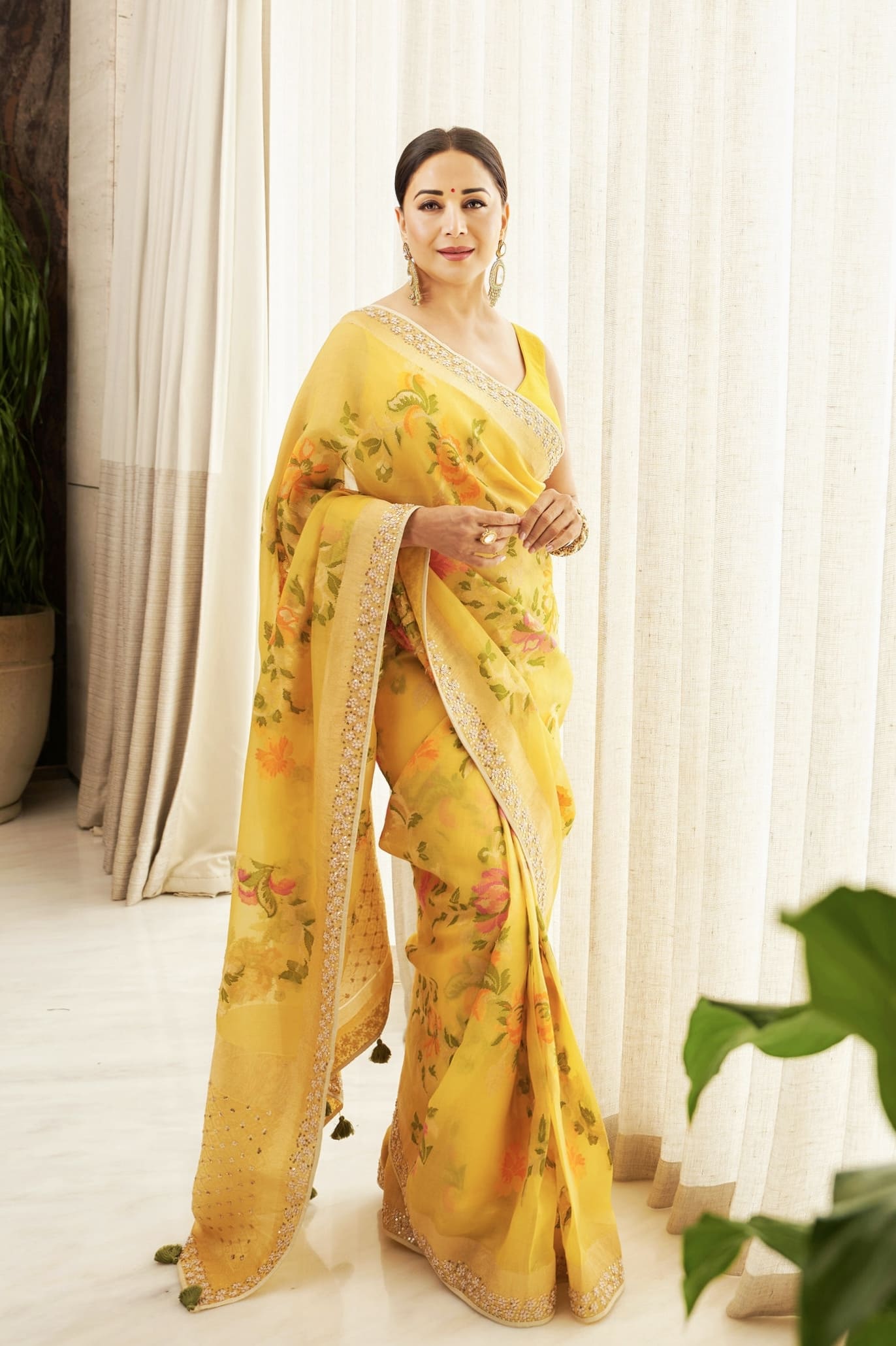 Madhuri Dixit inspired yellow Banarasi silk saree handwoven in Benaras with nature motifs for daytime festive wear