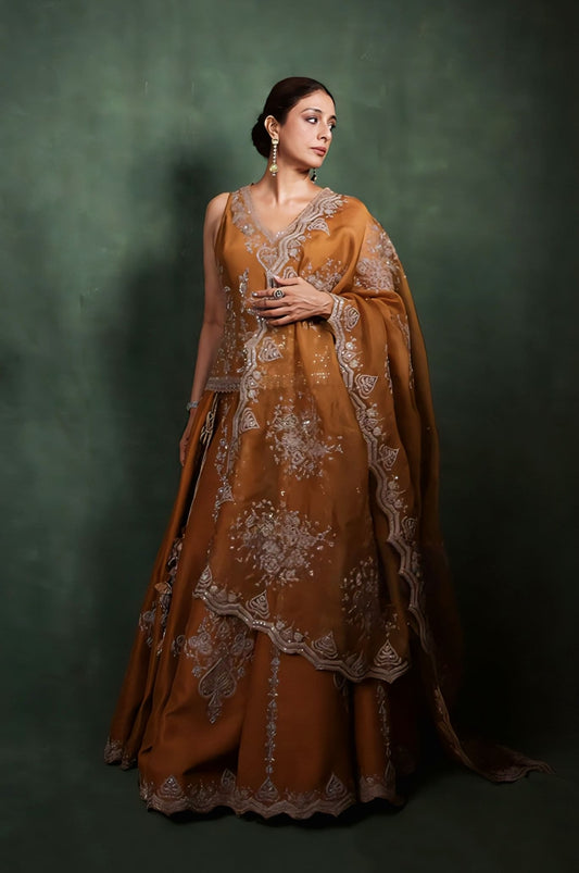 Tabu wearing yellow ochre Mehre Aafreen lehenga set with dori embroidery