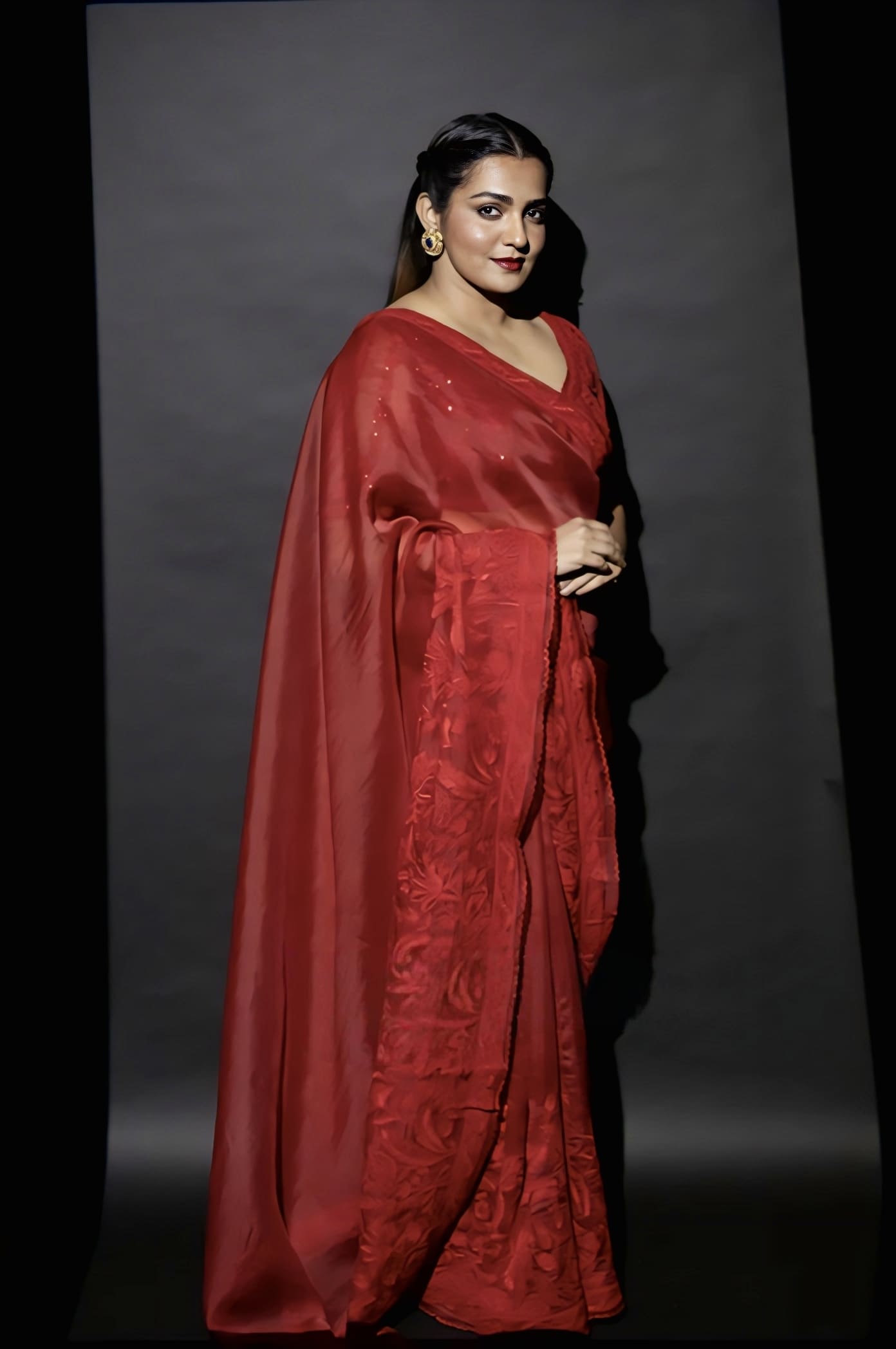 Red organza embroidered saree with net silk blouse inspired by Parvathy