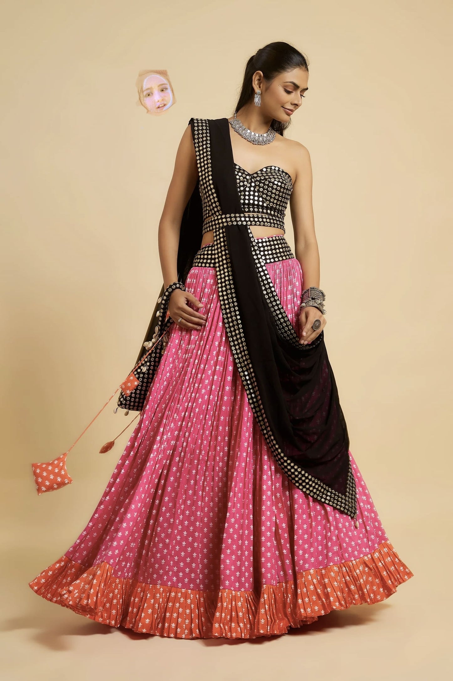 Woman wearing black mirror work blouse with pink lehenga and black dupatta for festive, wedding, Navratri, and party wear ethnic fashion.