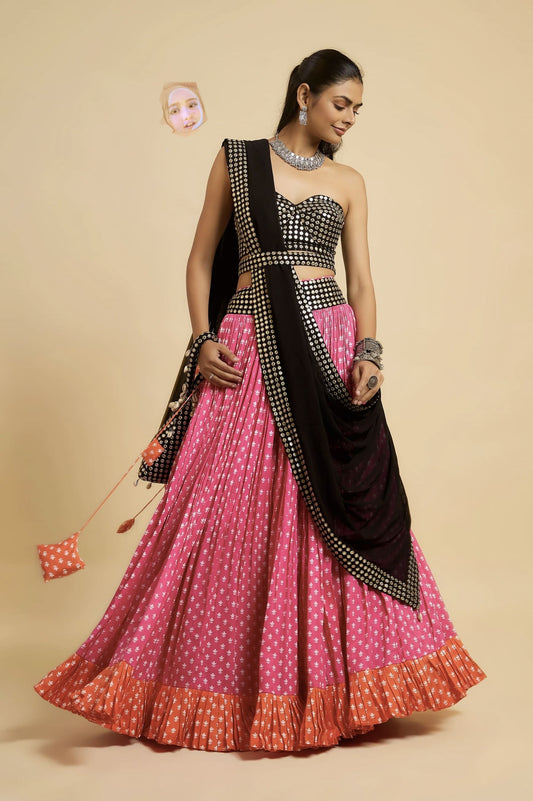 Woman wearing black mirror work blouse with pink lehenga and black dupatta for festive, wedding, Navratri, and party wear ethnic fashion.