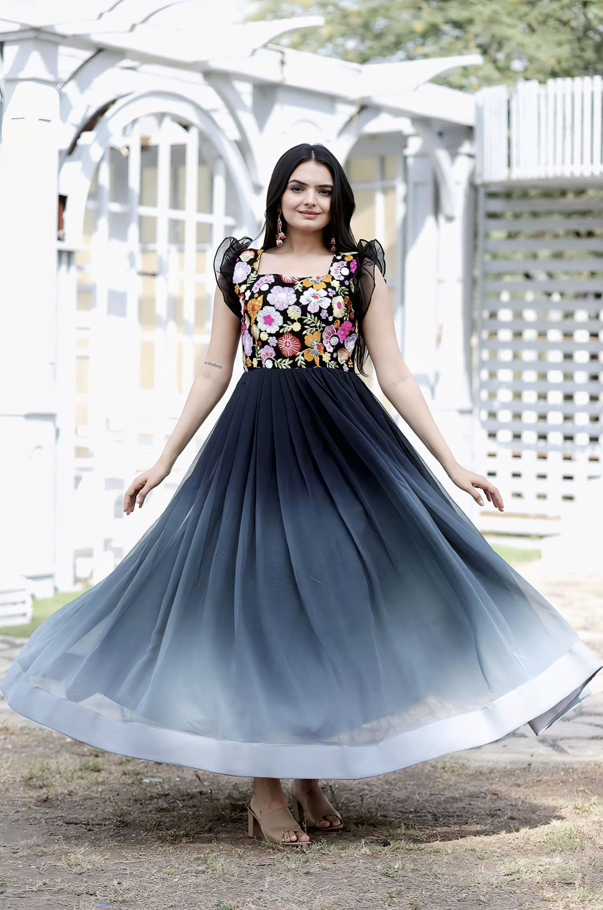 Black ombre georgette gown with floral embroidered bodice, sequins work, square neck, and double frill shoulder detailing for party wear and festive occasions