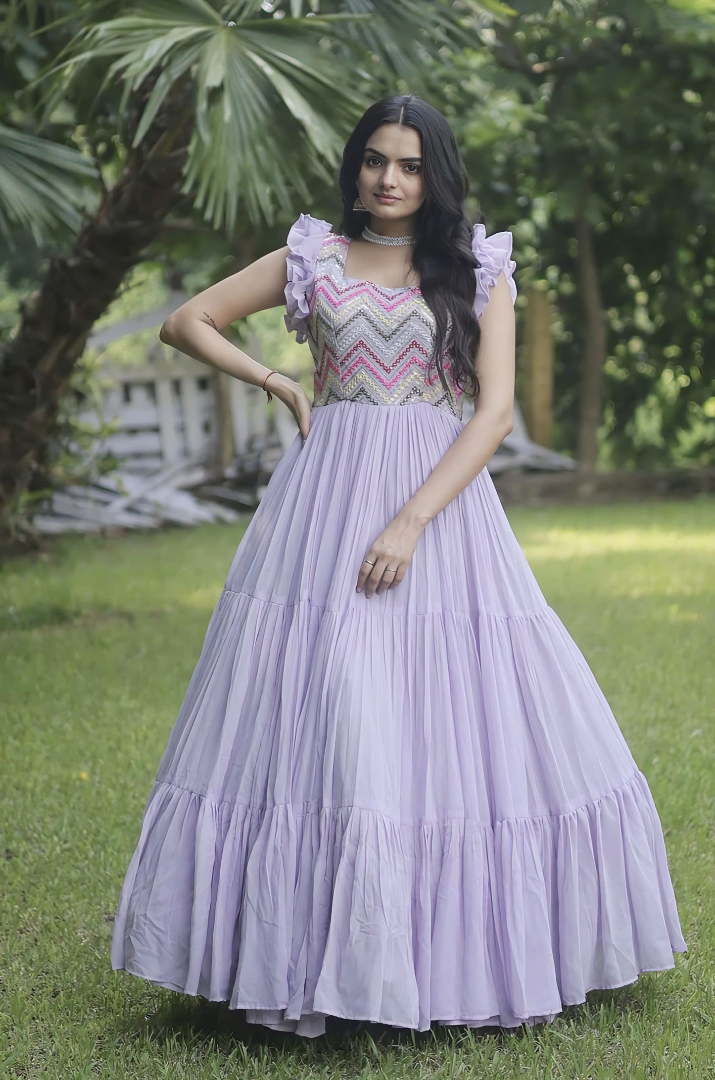 Purple faux georgette gown with heavy sequins embroidery, multithread work, sleeveless double frill shoulders, and ruffled hem for party and festive wear