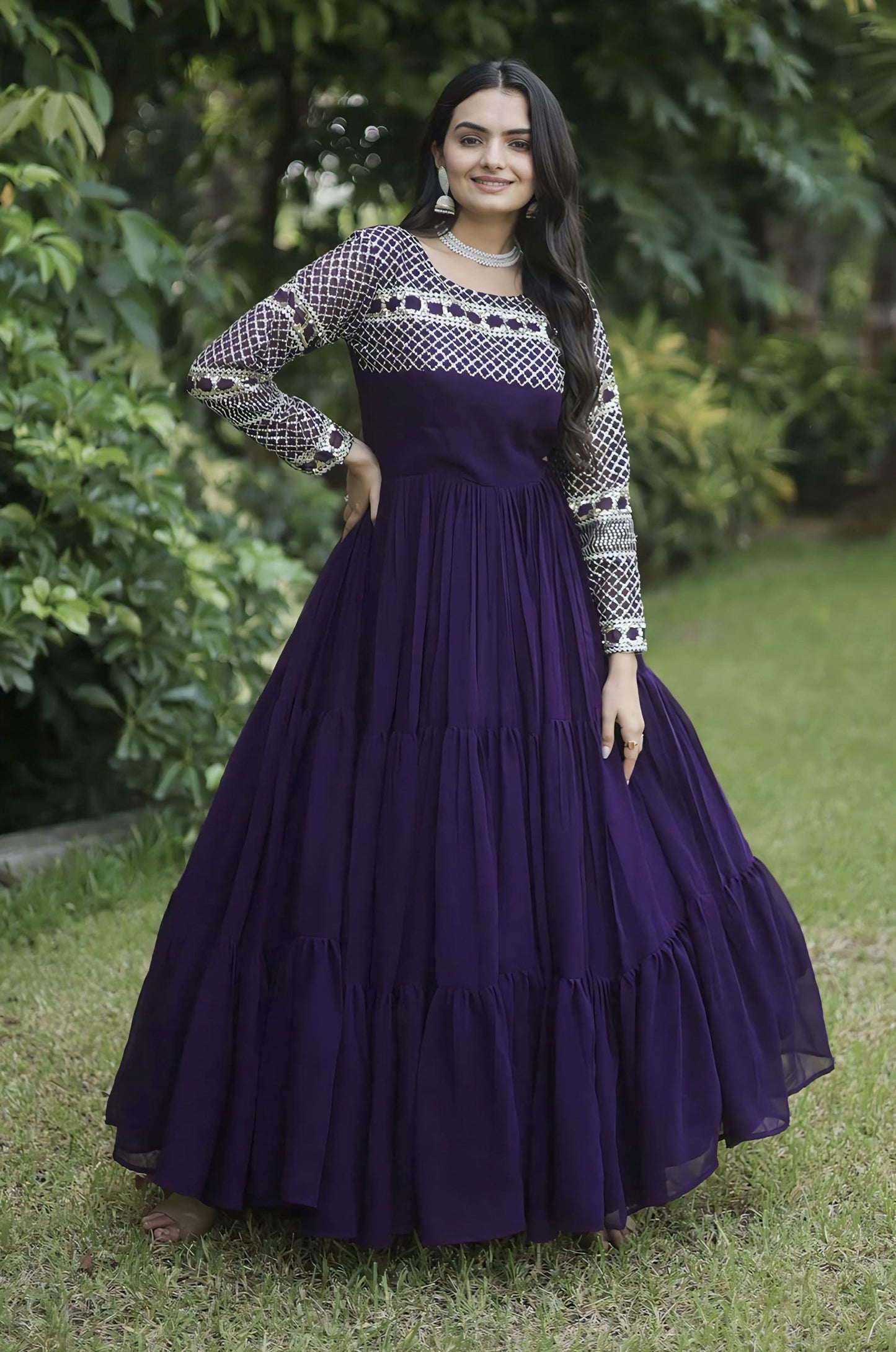 Wine purple faux blooming gown with zari and sequins embroidery, tiered layered design, full sleeves, round neck, and 12 meter flair for festive and wedding wear