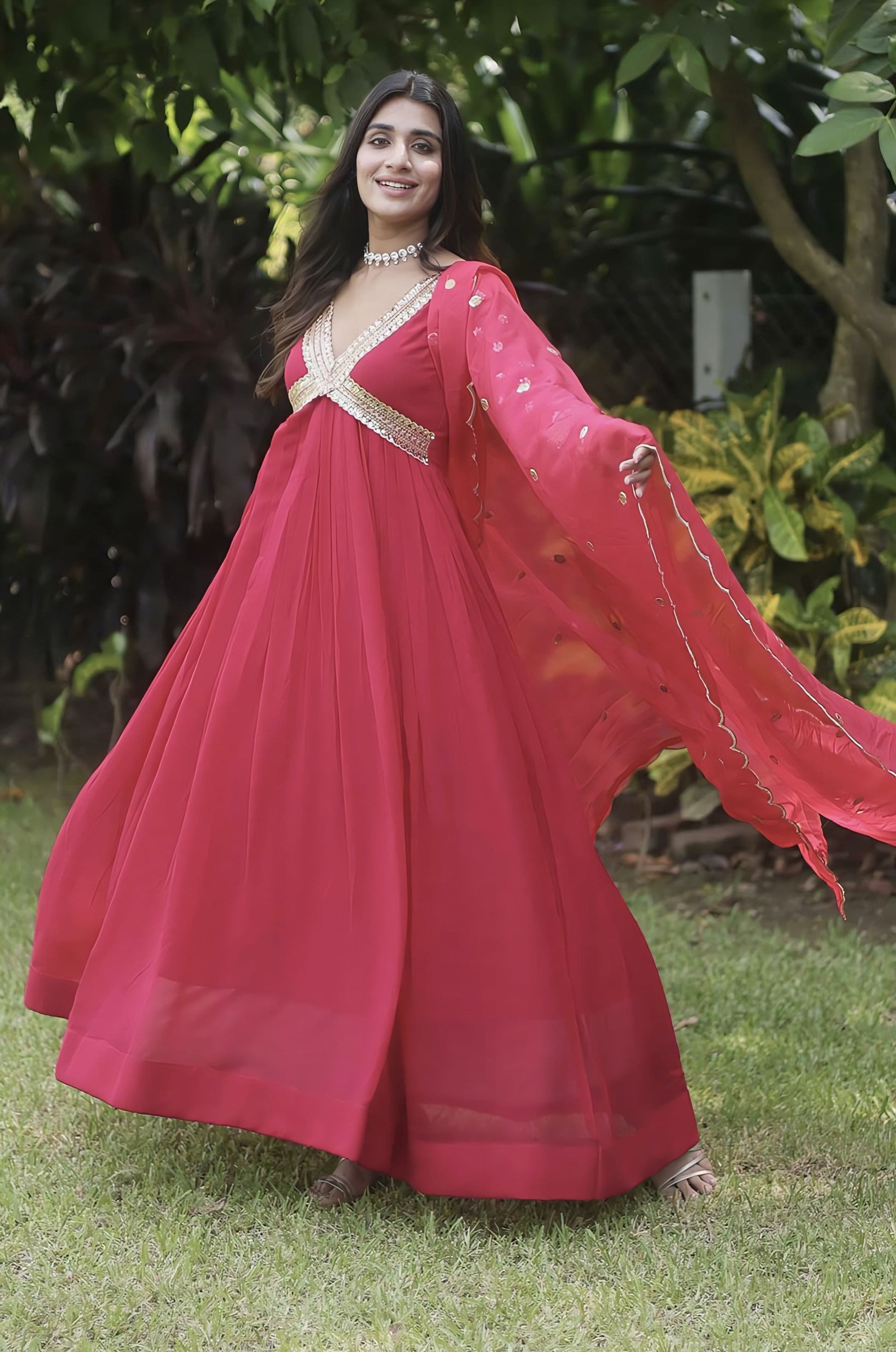 Rani pink faux blooming gown with zari sequins embroidery, fancy V-neck, full sleeves, cotton lining, and embroidered dupatta for festive and wedding wear