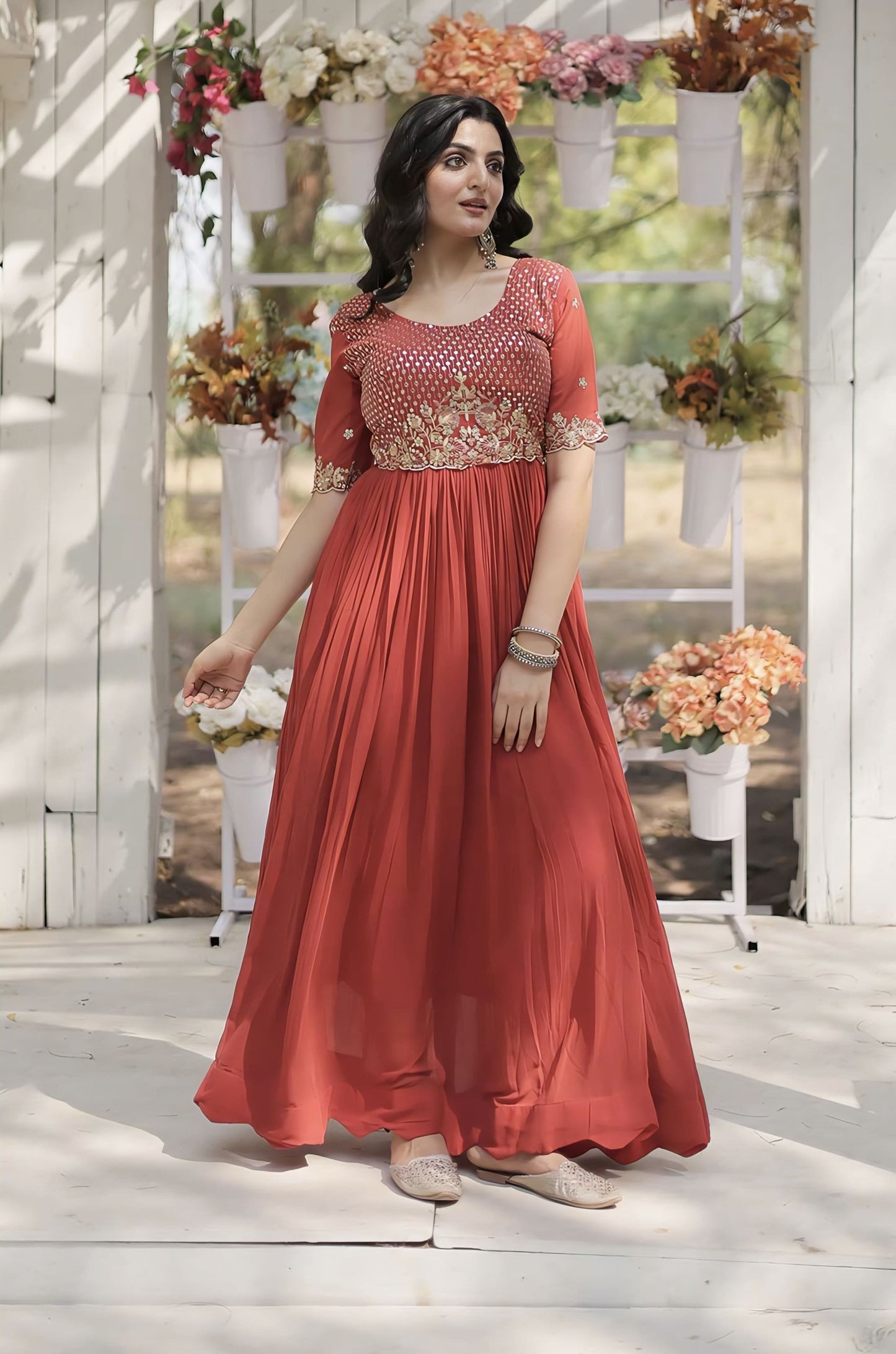 Orange faux blooming gown with zari sequins embroidery, fancy round neck, half sleeves, and cotton lining for festive and wedding wear
