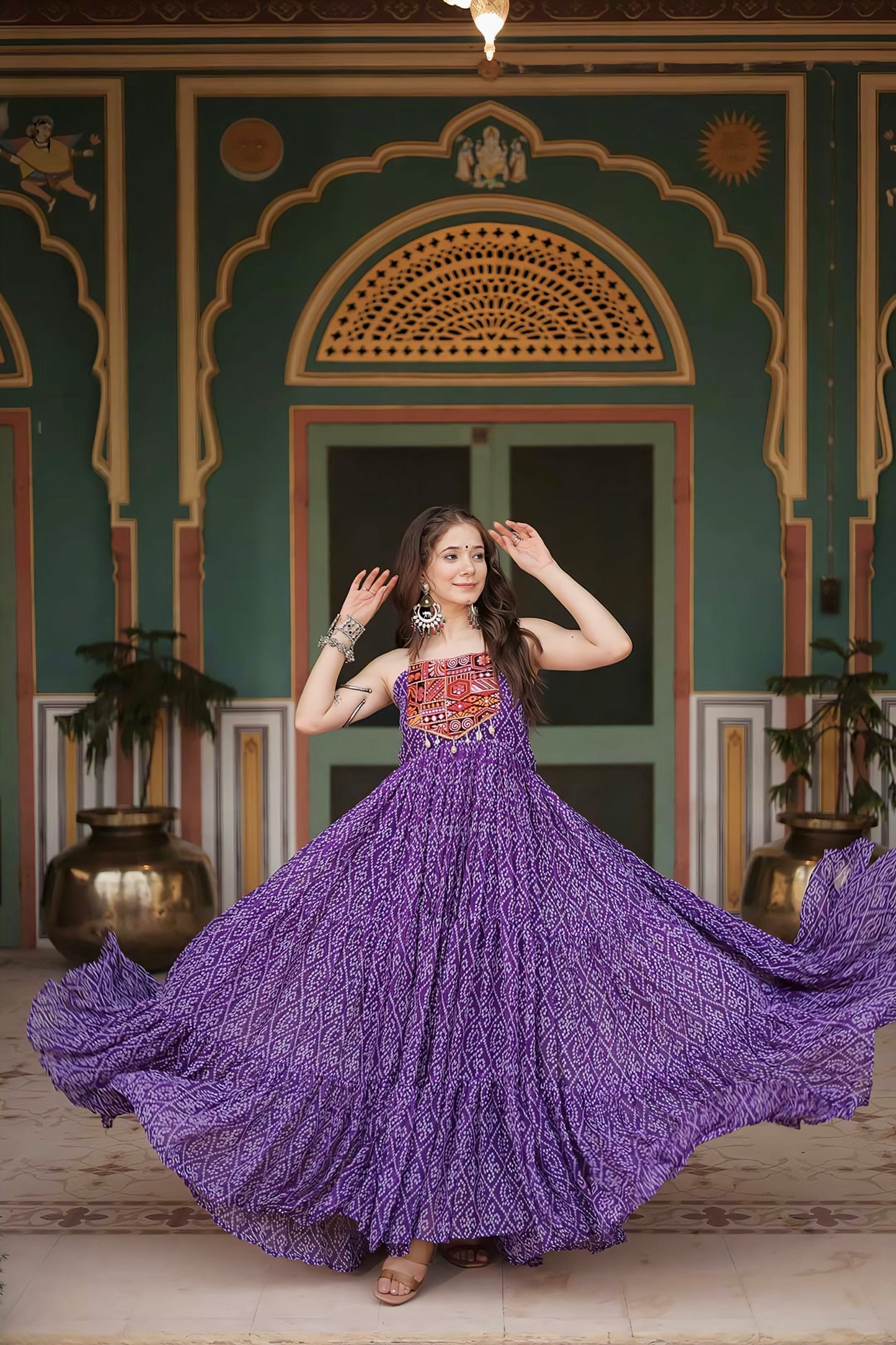 Purple Bandhani print georgette gown with embroidered mirror work yoke, Kutchi patchwork, sleeveless design, and cotton lining for festive and Navratri wear