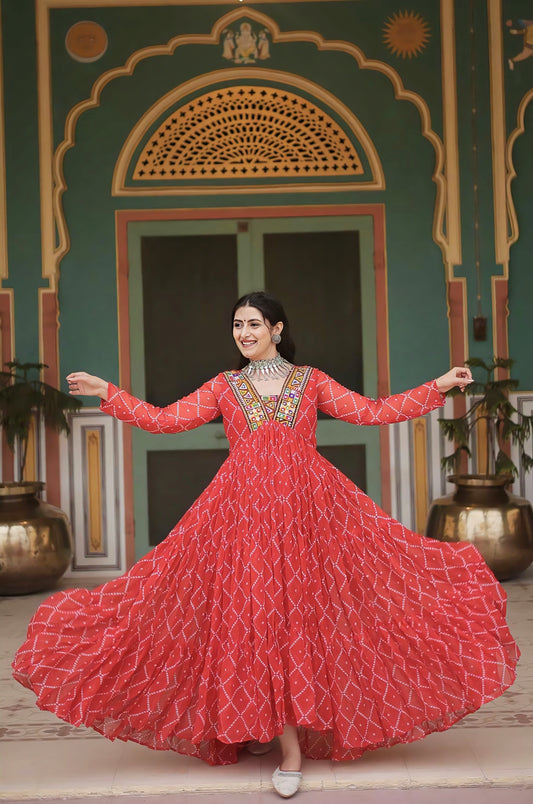 Orange Bandhani print georgette gown with embellished Kutchi patchwork yoke, full sleeves, and cotton lining for Navratri and festive wear