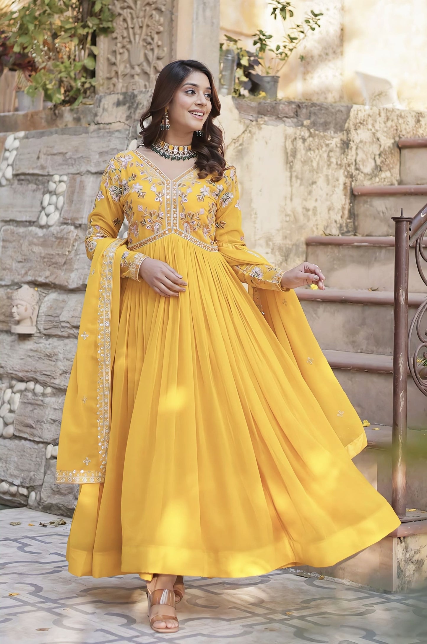 Yellow faux blooming gown with zari sequins embroidery, embroidered full sleeves, stylish V-neck, cotton lining, and designer dupatta for festive and wedding wear