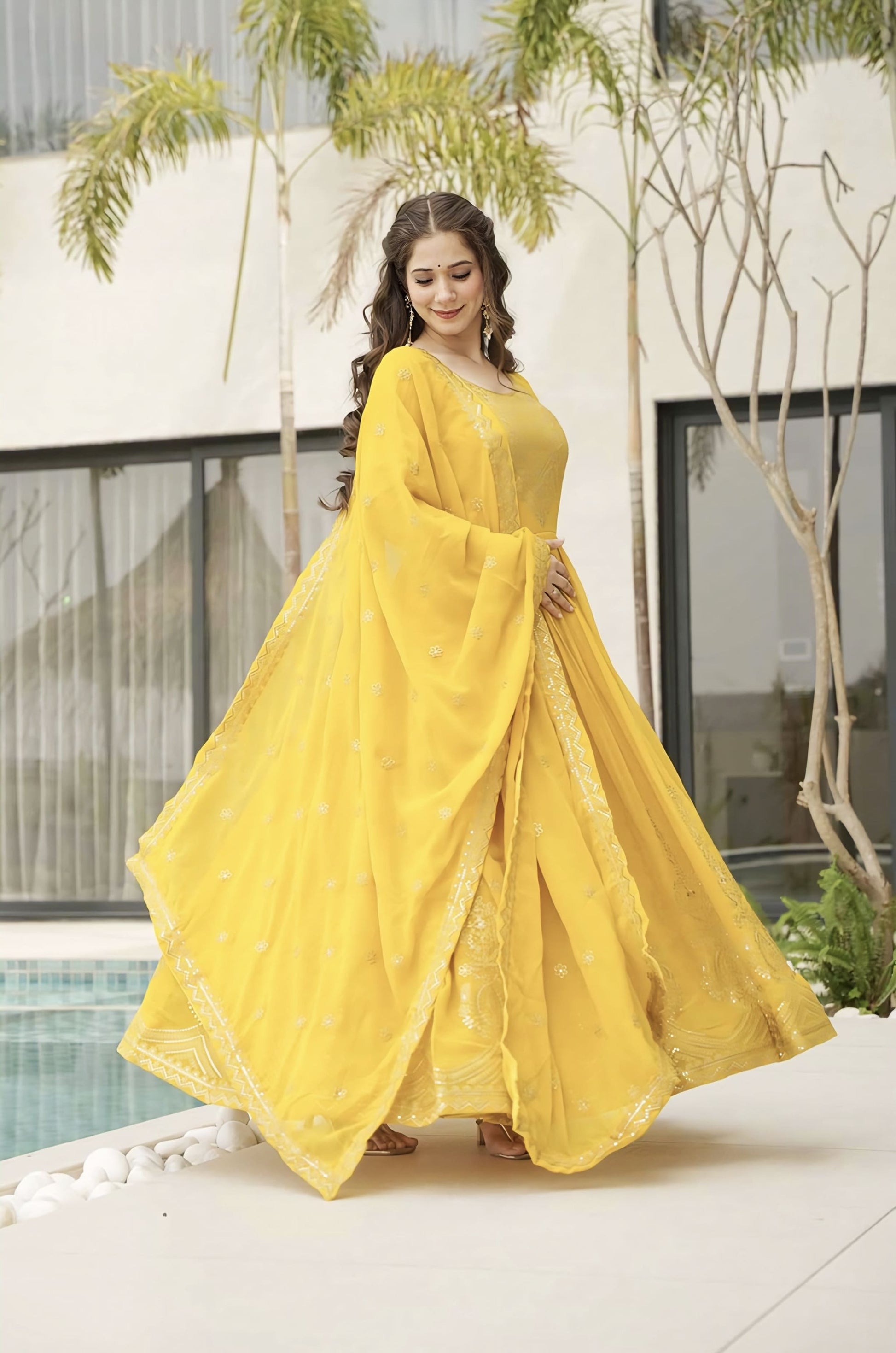 Yellow faux blooming gown with zari sequins embroidery, full sleeves, round neck, cotton lining, and designer dupatta with lace border for festive and wedding wear