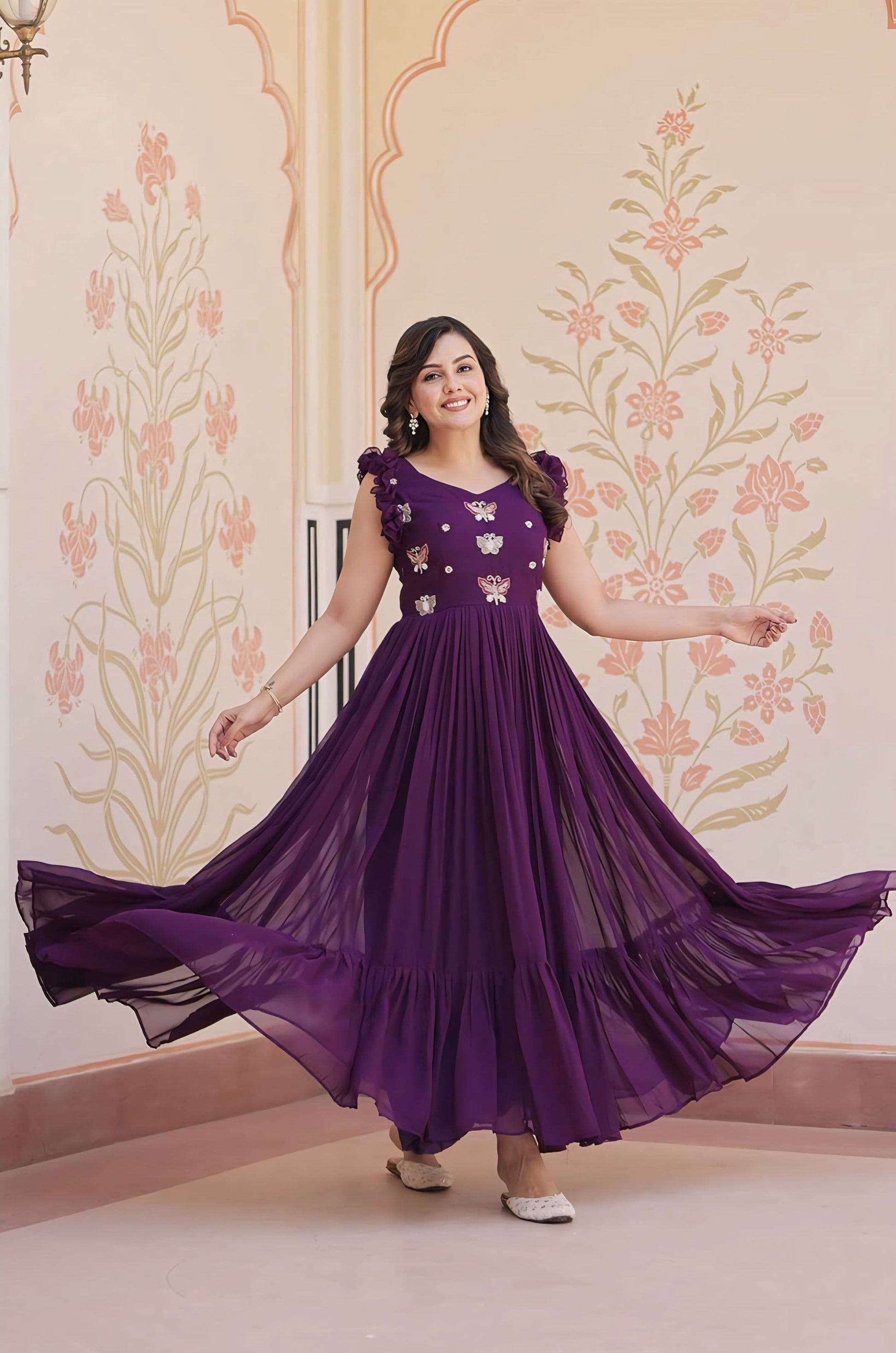 Purple faux blooming gown with sequins, beads, and multi thread embroidery, fancy V-neck, sleeveless double frill shoulders, and cotton lining for festive wear
