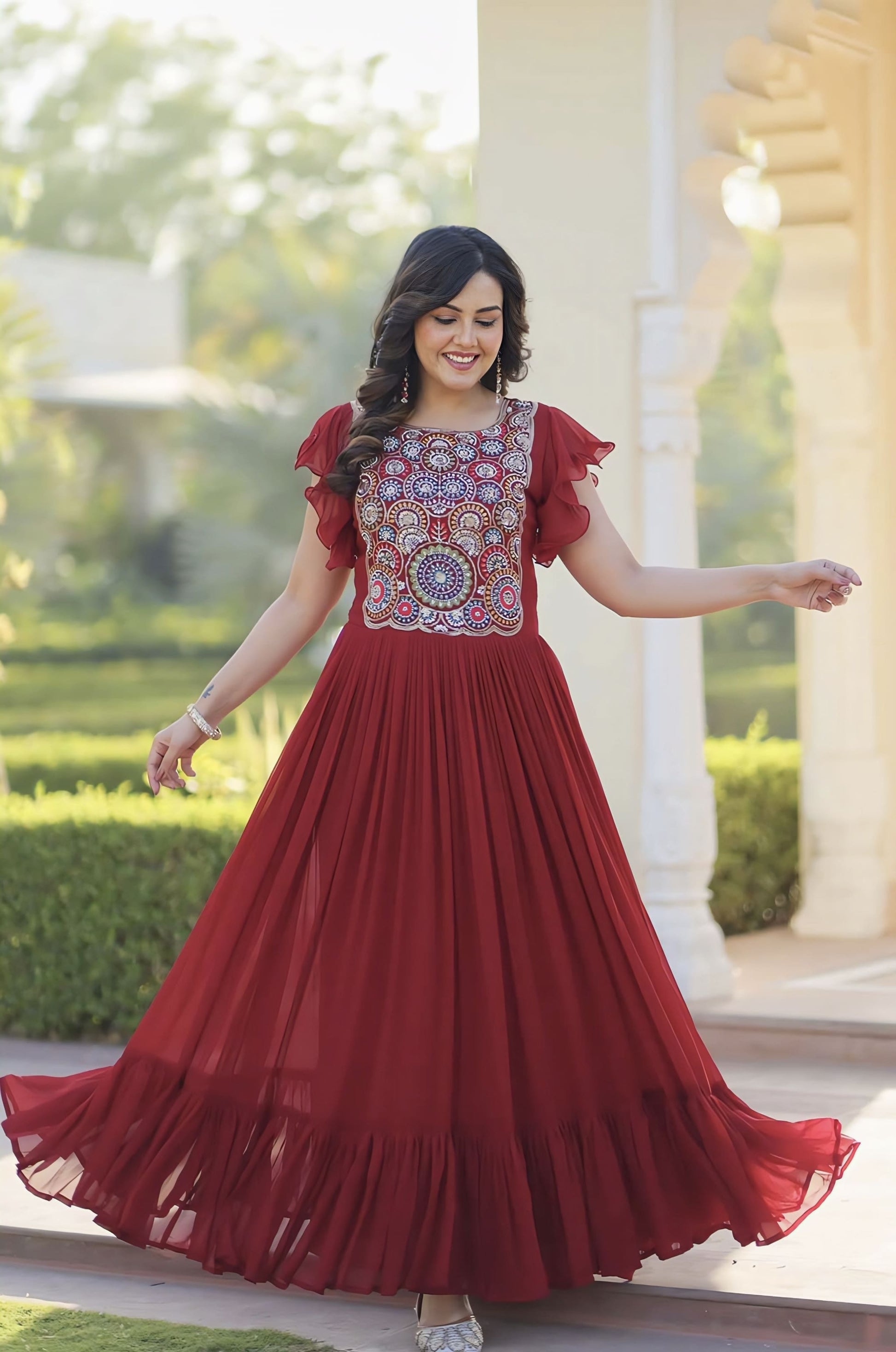 Maroon faux blooming frill gown with beads sequins embroidery, bell sleeves, round neck, and 7 meter flair for festive and wedding wear