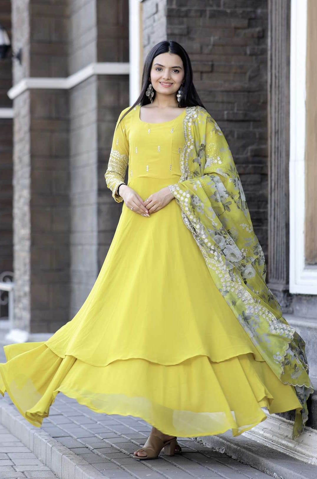 Yellow faux blooming gown with zari sequins embroidery, full sleeves, double flair, and floral organza dupatta with sequins cutwork for festive and wedding wear