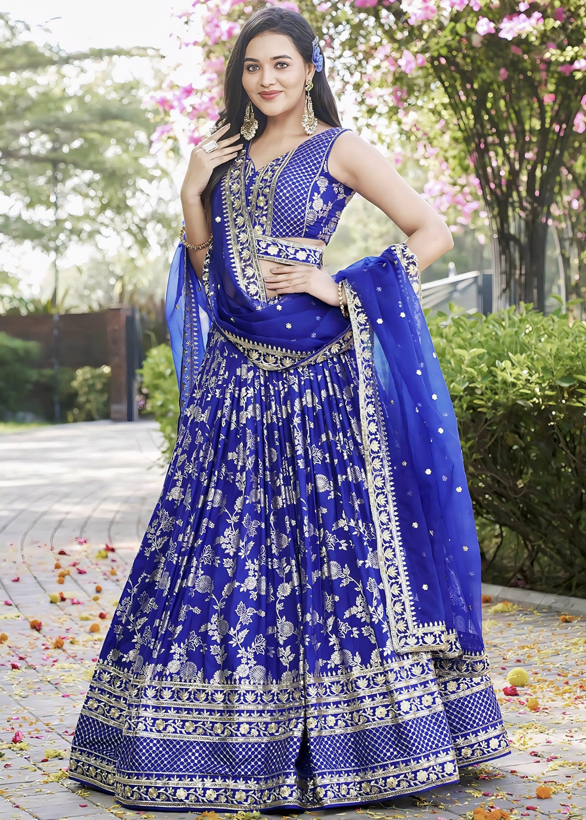 Royal blue art silk lehenga choli with zari woven motifs, sequins embroidered border, matching choli, and organza dupatta for wedding and festive wear