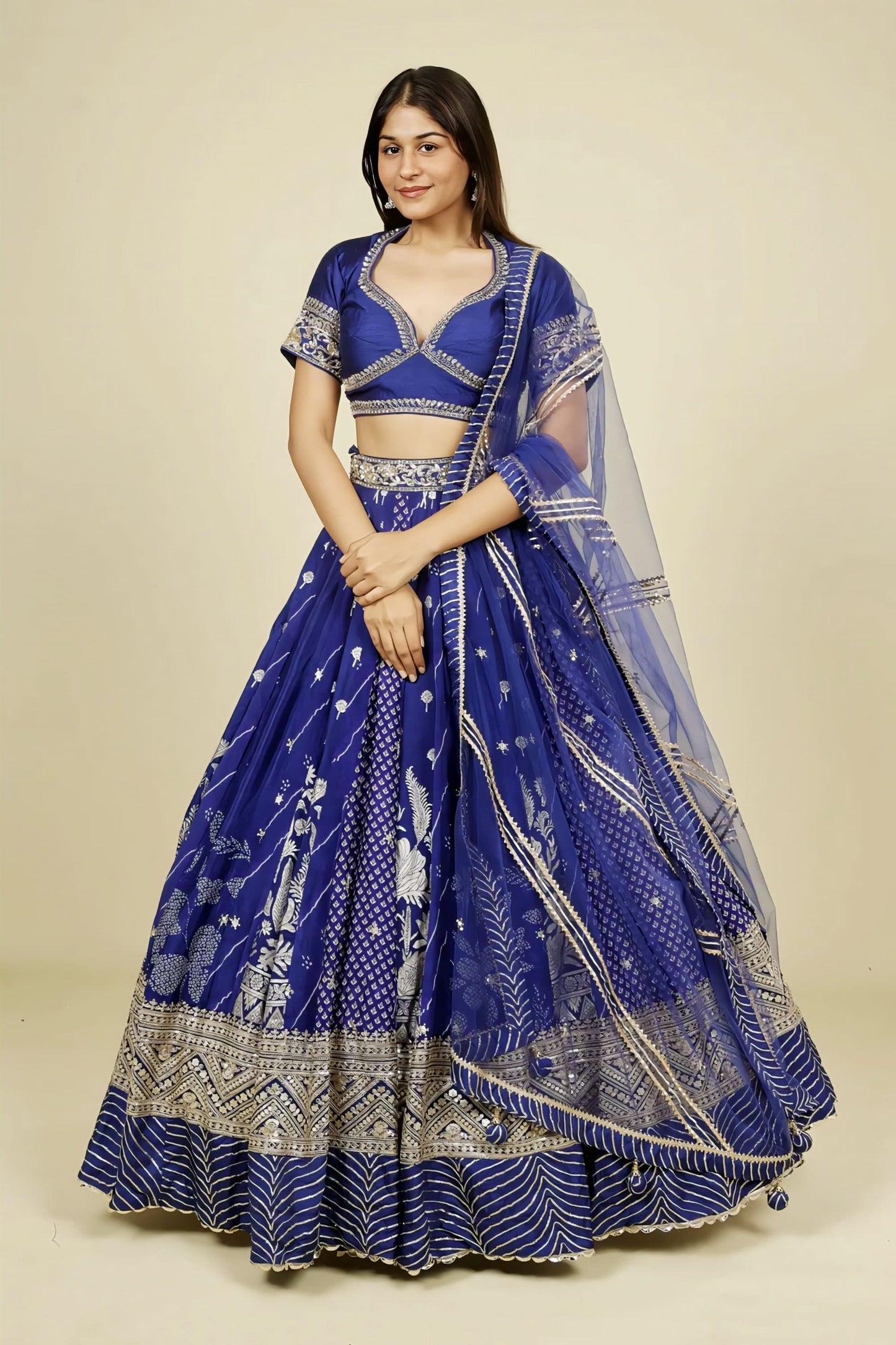 Royal blue crepe silk lehenga set with zardozi, gota, zari, and sequins embroidery, embroidered silk blouse, and net dupatta for wedding and festive wear