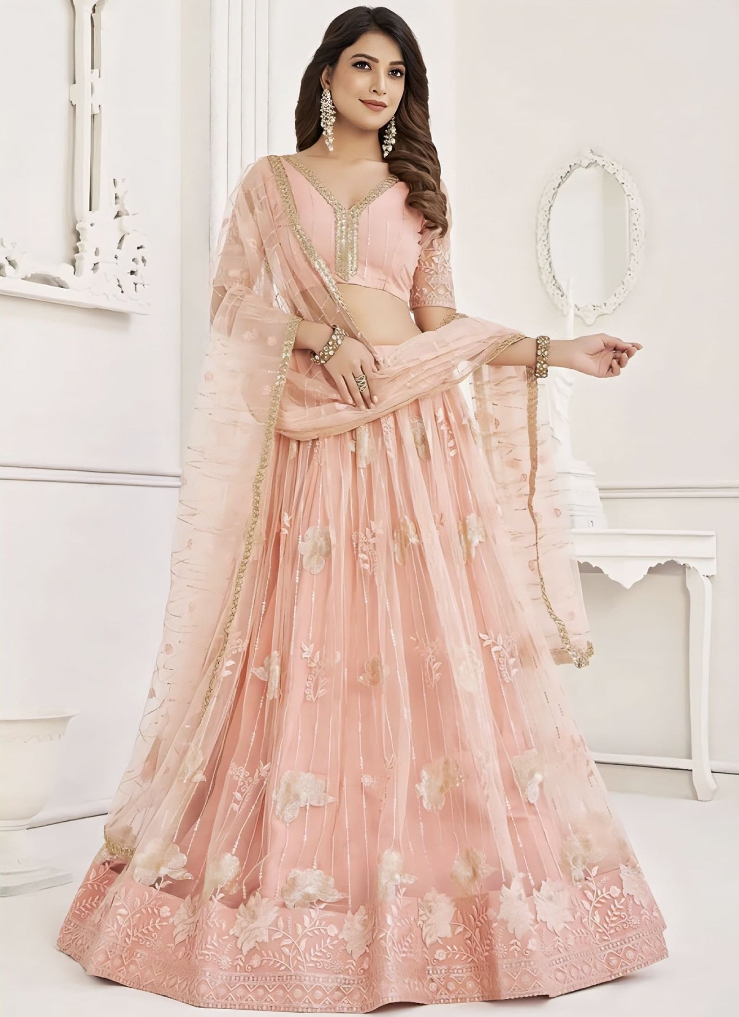 Peach embroidered net lehenga choli with sequins, zari, and thread work, matching net choli, and dupatta for wedding and festive wear