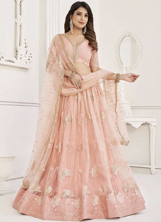 Peach embroidered net lehenga choli with sequins, zari, and thread work, matching net choli, and dupatta for wedding and festive wear