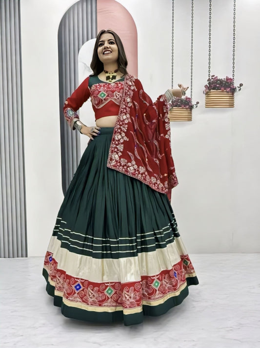 Green red cotton Navratri lehenga choli with embroidery thread work, sequins detailing, lace border, and embroidered fox georgette dupatta for Garba wear