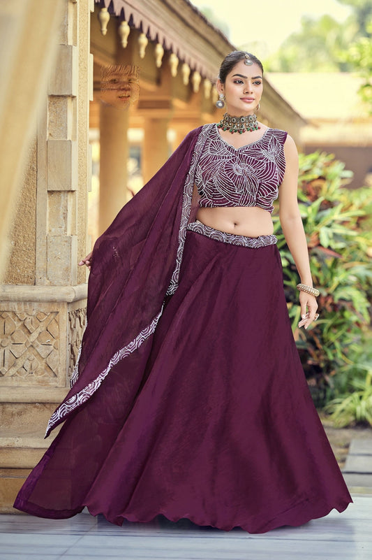 Wine embroidered silk lehenga choli with sequins work and matching dupatta for wedding and festive wear