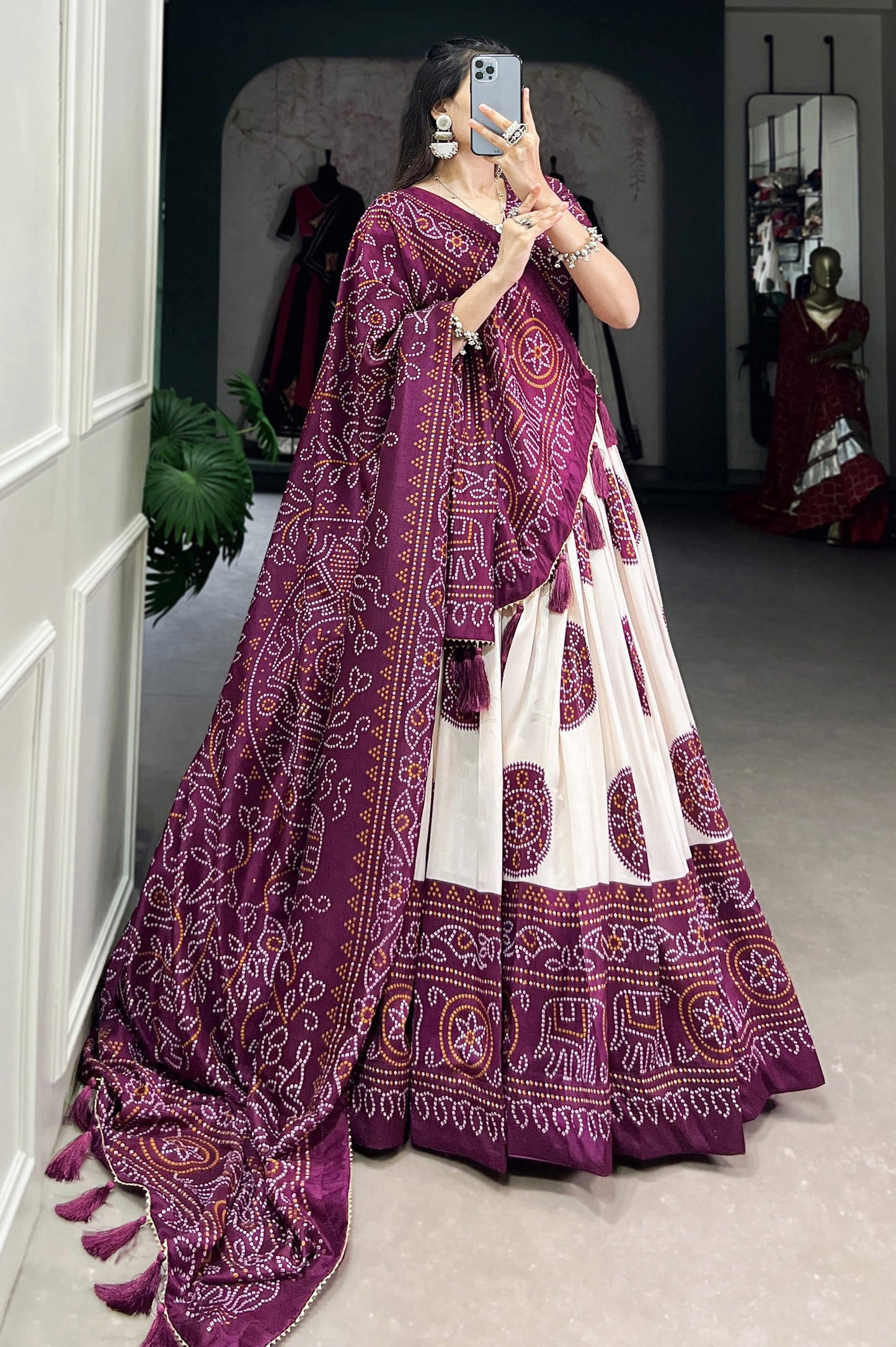 Wine Bandhani printed tussar silk lehenga choli with Kalamkari work, matching silk blouse, and silk dupatta with tassels and Gota Patti lace border