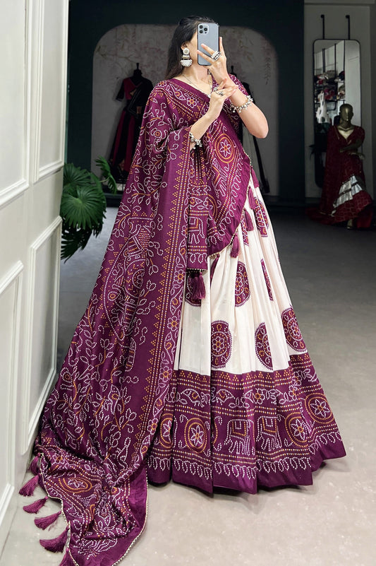 Wine Bandhani printed tussar silk lehenga choli with Kalamkari work, matching silk blouse, and silk dupatta with tassels and Gota Patti lace border