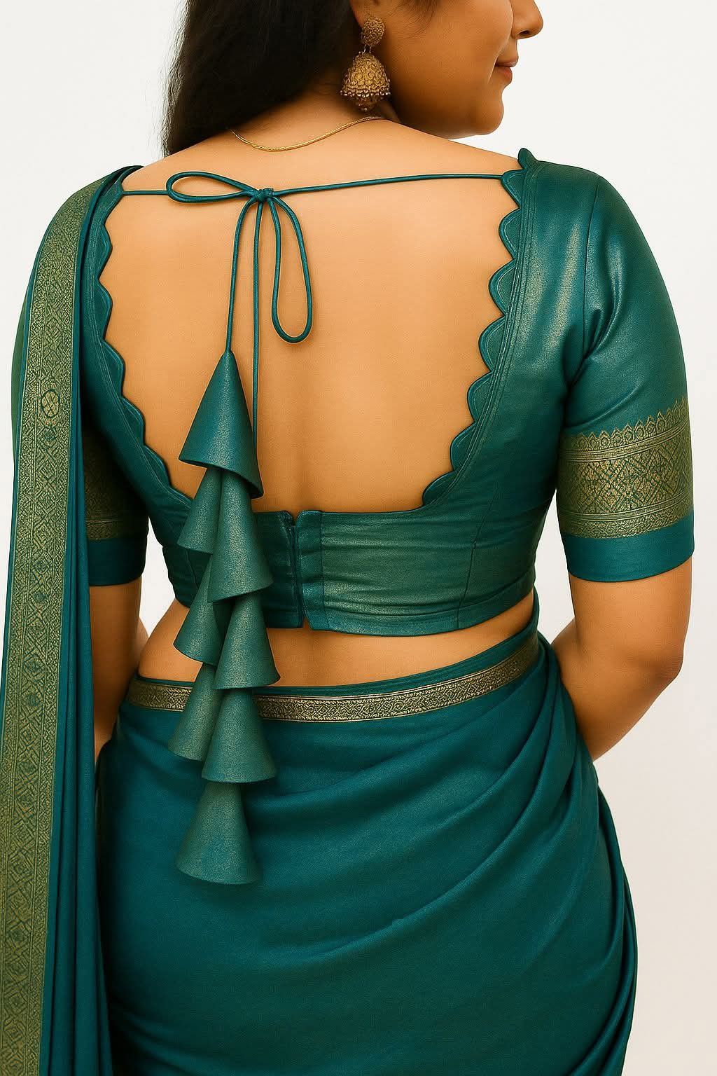 Teal saree with open back design on a plain background