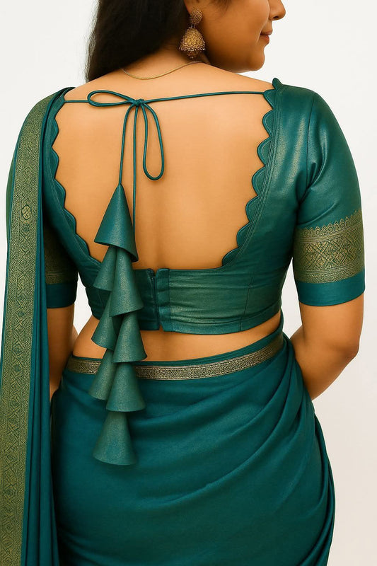 Teal saree with open back design on a plain background